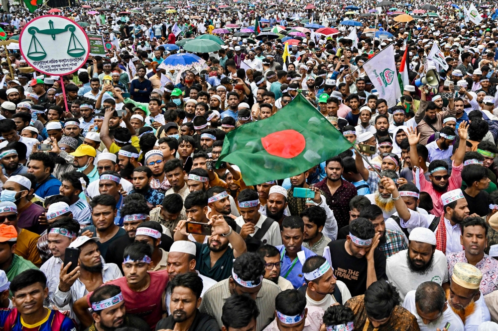 Jamaat-e-Islami party leaders and activists wave Bangladesh’s national flag during a rally held to call for the introduction of a proportional representation system in the country’s forthcoming general election and press other demands at the Suhrawardy Udyan in Dhaka on July 19, 2025. — AFP pic