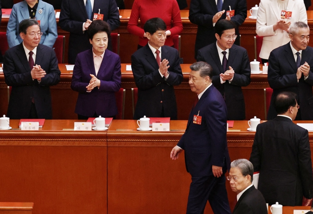 Chinese President Xi Jinping (C) leaves during the closing session of the National People's Congress (NPC) at the Great Hall of the People in Beijing. — AFP pic