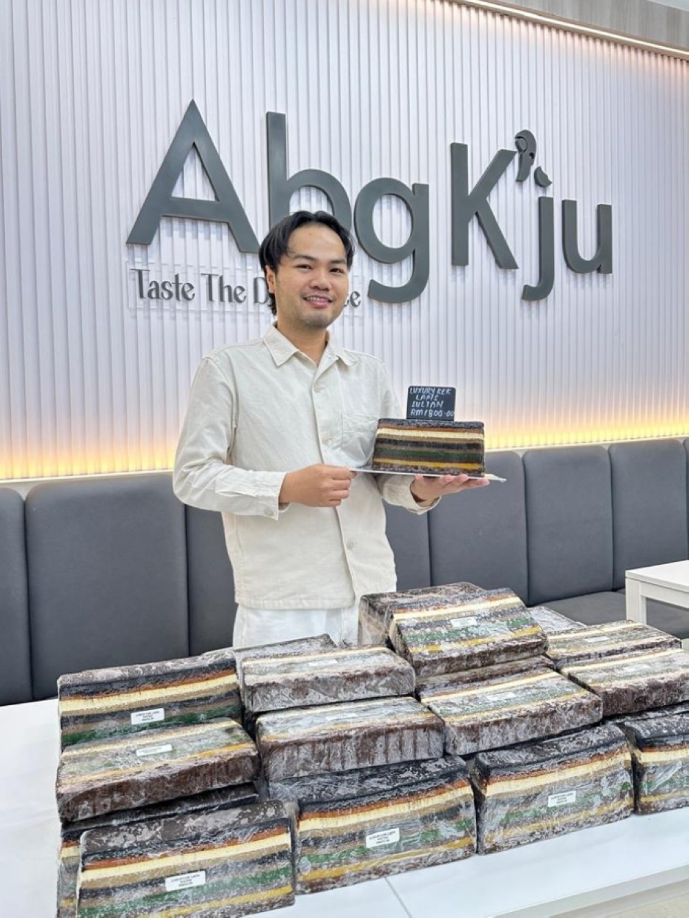 Adhad holding his creation – Luxury Kek Lapis Sultan. — Handout via The Borneo Post