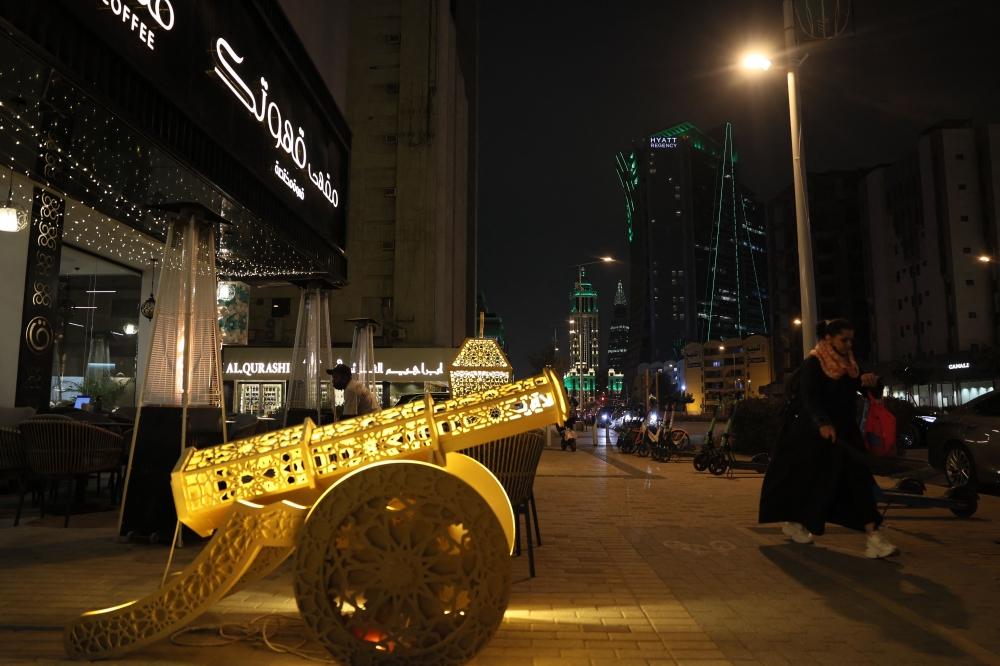 A woman walks past a coffee shop in the Saudi capital Riyadh. The oil-rich Gulf has borne the brunt of Iran’s attacks in response to US-Israeli strikes that sparked the Middle East war, with Tehran targeting US assets but also civilian infrastructure, including energy facilities and airports. — AFP pic