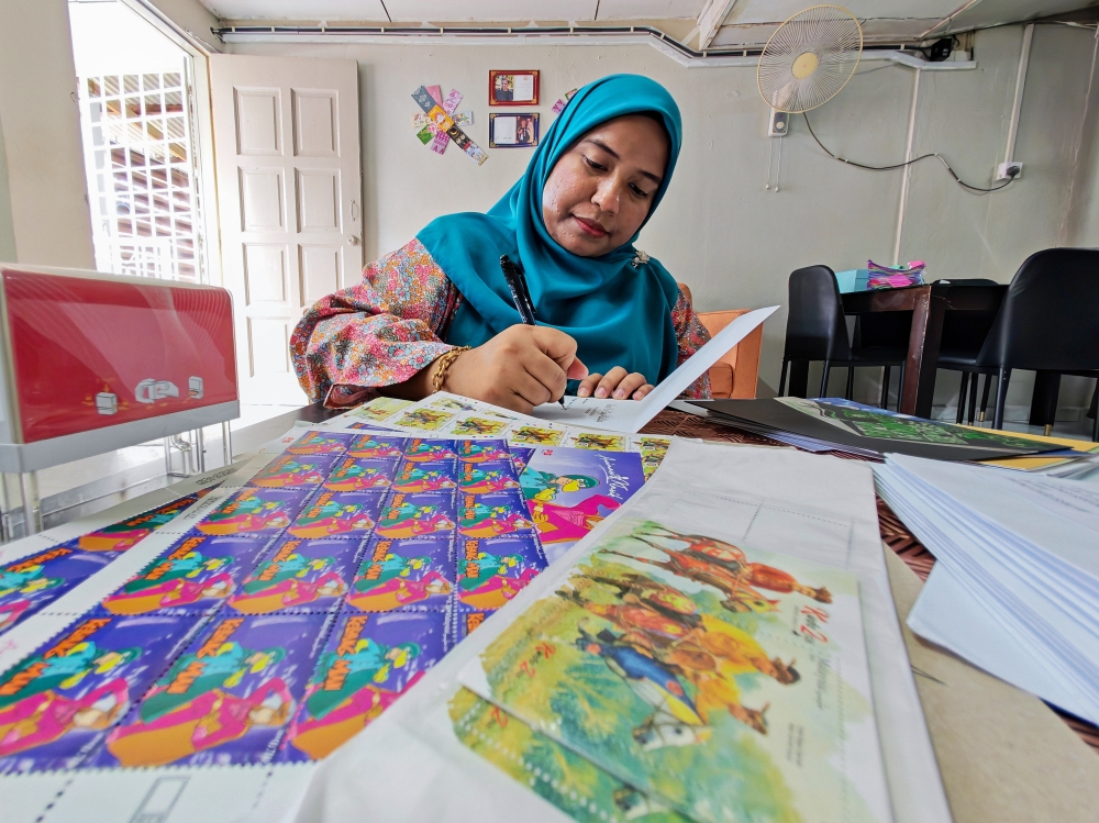 Norain Mohamad Hadi, 34, writes Raya cards, some addressed to dignitaries, at her home in Bandar Tun Razak, Kuala Lumpur, March 13, 2026. — Bernama pic