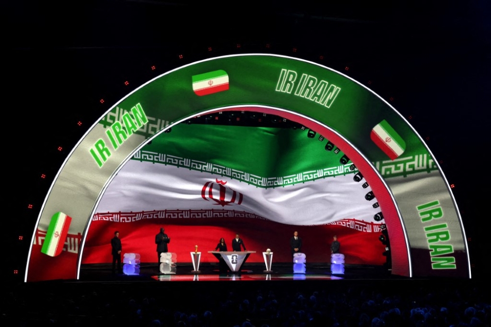 Iran is illuminated on the screen during the Fifa World Cup 2026 Official Draw. Iran coach Amir Ghalenoei backed the national team’s statement insisting their World Cup place cannot be taken away. — AFP pic