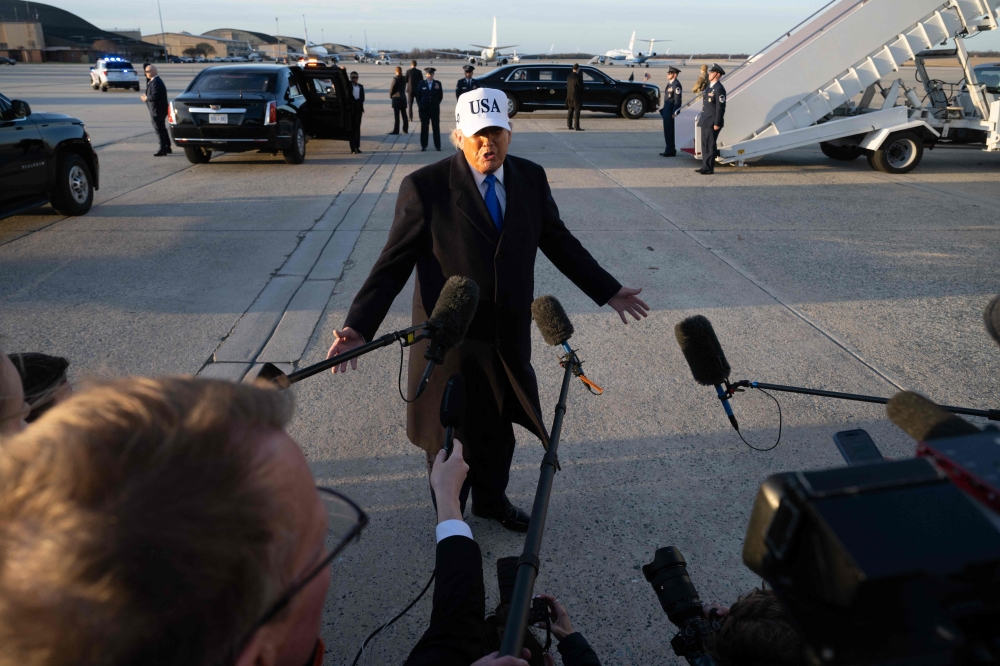 US President Donald Trump speaks to reporters before boarding Air Force One as he departs Joint Base Andrews in Maryland on March 13, 2026. — AFP pic