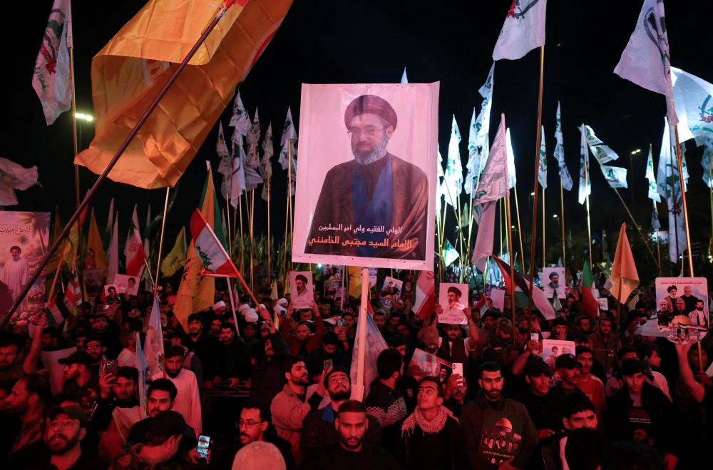 A man holds a placard with an image depicting Iran’s new Supreme Leader Mojtaba Khamenei, during a Shi’ite Muslims gathering marking the annual al-Quds Day (Jerusalem Day) in Baghdad, Iraq, March 13, 2026. — Reuters pic