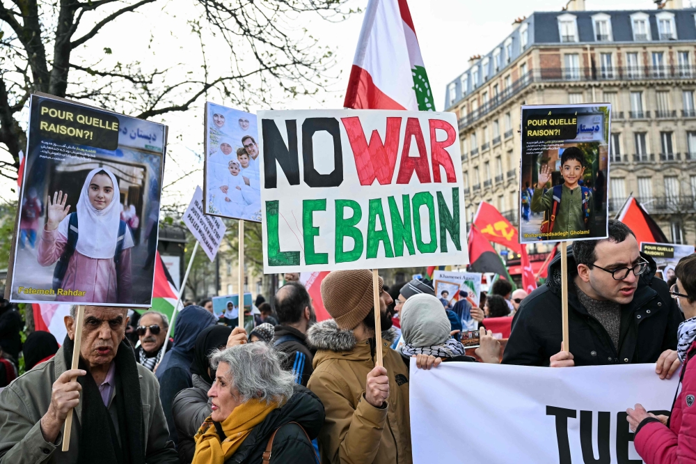 A protester holds a banner reading ‘No war Lebanon’ during a march against Middle East's war, triggered by the joint US-Israeli strikes alongside a rally against racism, fascism and state violence, in Paris on March 14, 2026. — AFP pic 