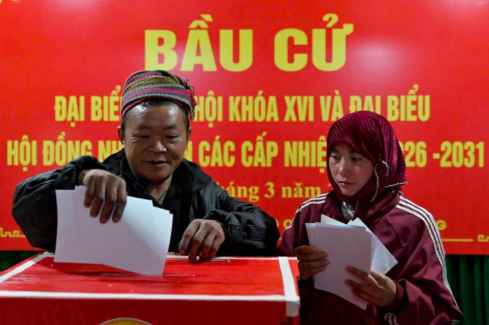 Ethnic minority citizens cast their votes inside a polling station in the northern Vietnamese province of Tuyen Quang on March 15, 2026. — AFP pic 