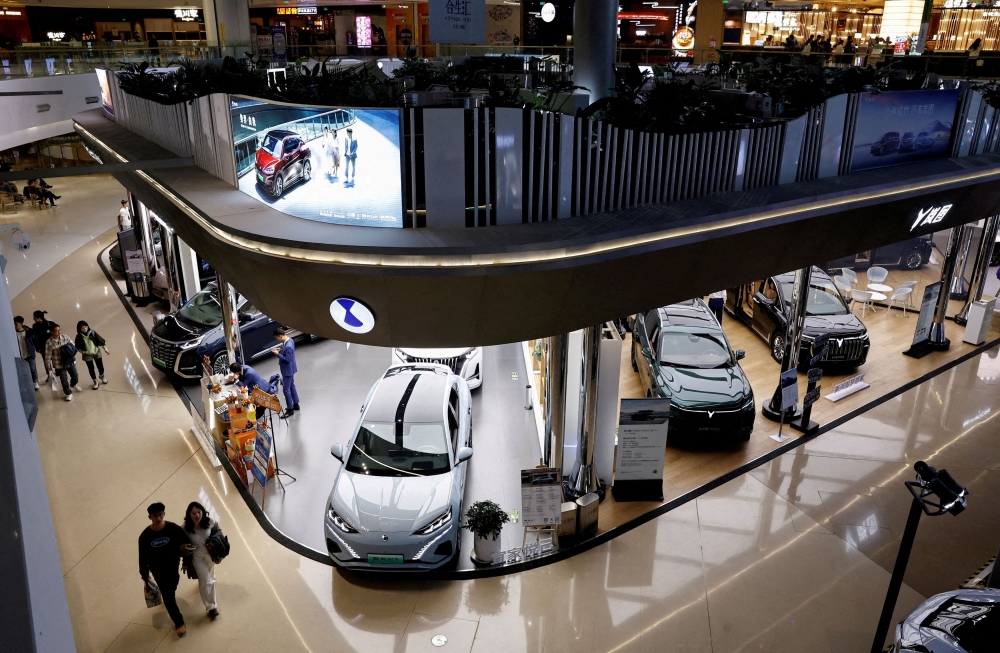 Shopping malls in major Chinese cities are seeing a rapid turnover of ground‑floor tenants as electric vehicle showrooms close and new brands move in to capture foot traffic. — Reuters pic  