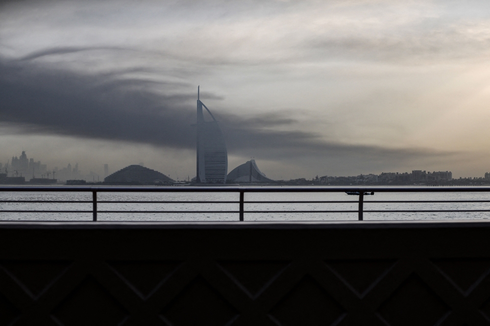 Explosions rattled buildings in Dubai and a large cloud of smoke hung over a central area of the Middle East financial hub on March 13, 2026. — AFP pic