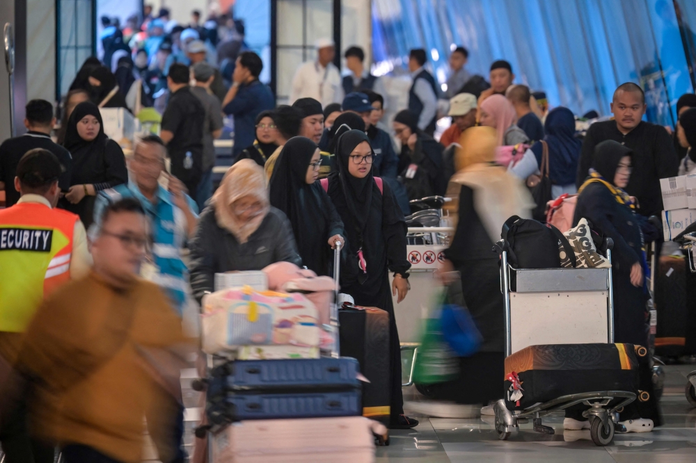 Indonesian Muslims performing the Umrah pilgrimage arrive home from Saudi Arabia at Soekarno-Hatta International Airport in Tangerang, Banten, on March 10, 2026, amid the war in the Middle East. — AFP pic 