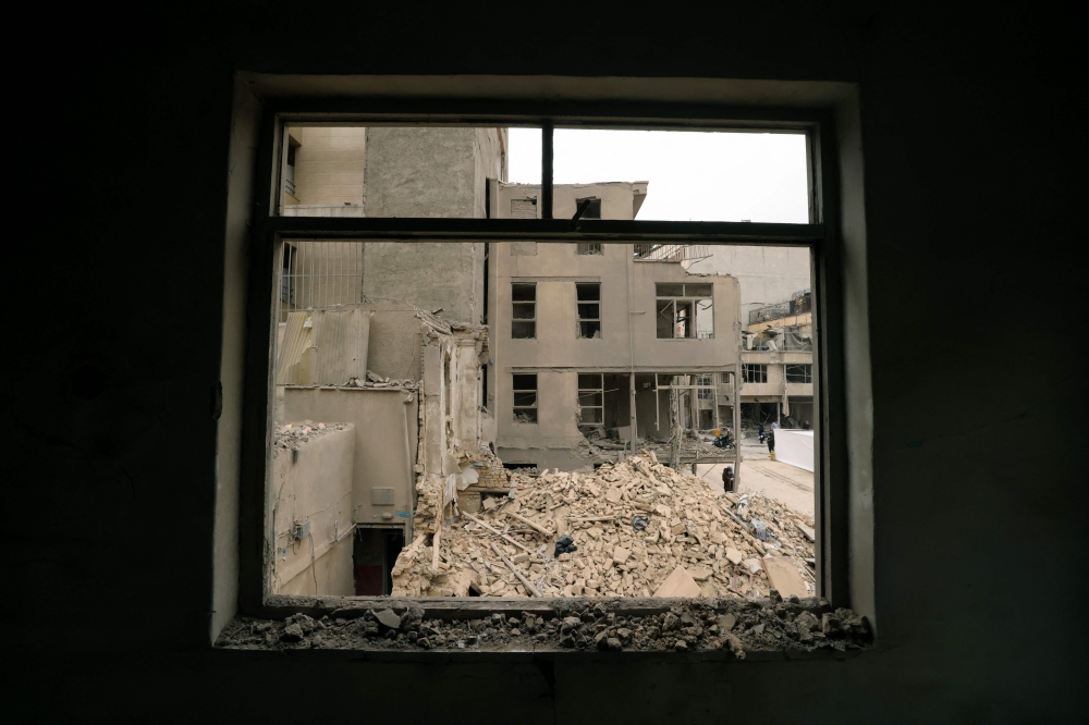 A view of a damaged residential neighbourhood following a military strike on the Iranian capital Tehran on March 15, 2026. — AFP pic