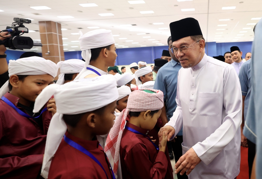 Prime Minister Datuk Seri Anwar Ibrahim shakes hands with tahfiz students attending a breaking of fast ceremony at the Second Central Lecture Hall Complex, Universiti Malaysia Sabah (UMS) in Kota Kinabalu on March 15, 2026. — Bernama pic