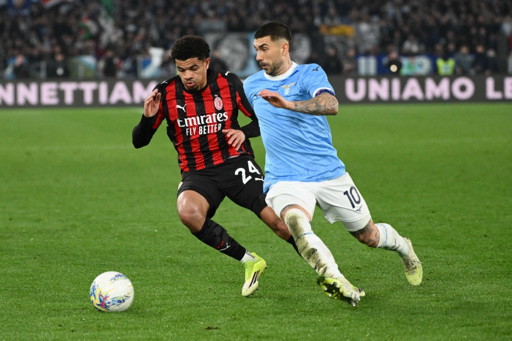 AC Milan's Swiss defender #24 Zachary Athekame (L) and Lazio's Italian midfielder #10 Mattia Zaccagni (R) fight for the ball during the Italian Serie A football match between Lazio and AC Milan at the Olympic Stadium in Rome on March 15, 2026. — AFP pic
