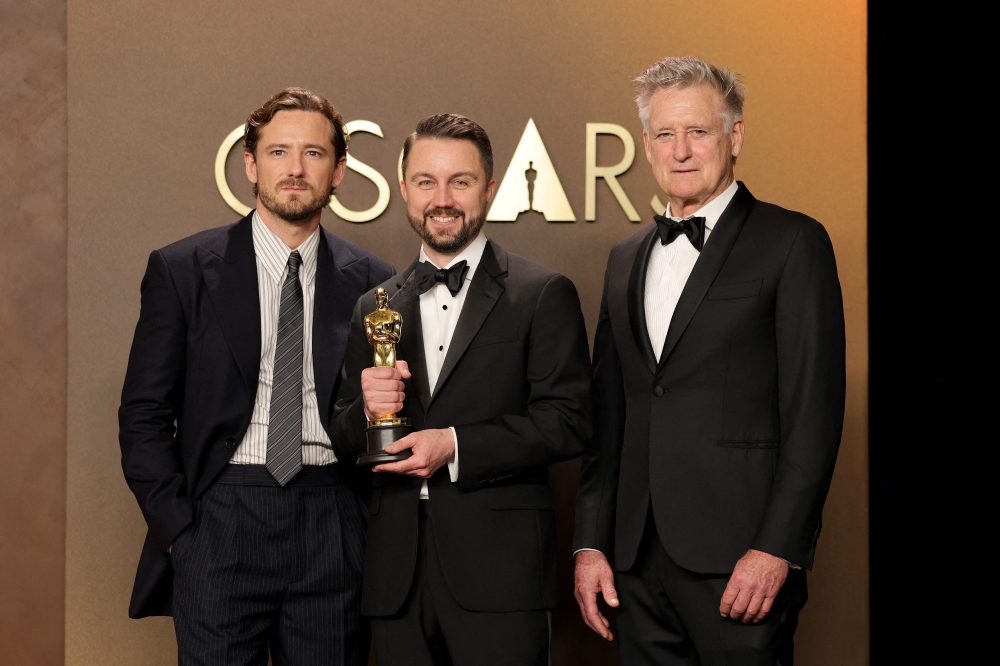 Andy Jurgensen poses with Lewis Pullman (left) and Bill Pullman after winning Best Film Editing for ‘One Battle After Another’ at the 98th Oscars press room, Dolby Theatre, Hollywood, March 15, 2026. — AFP pic