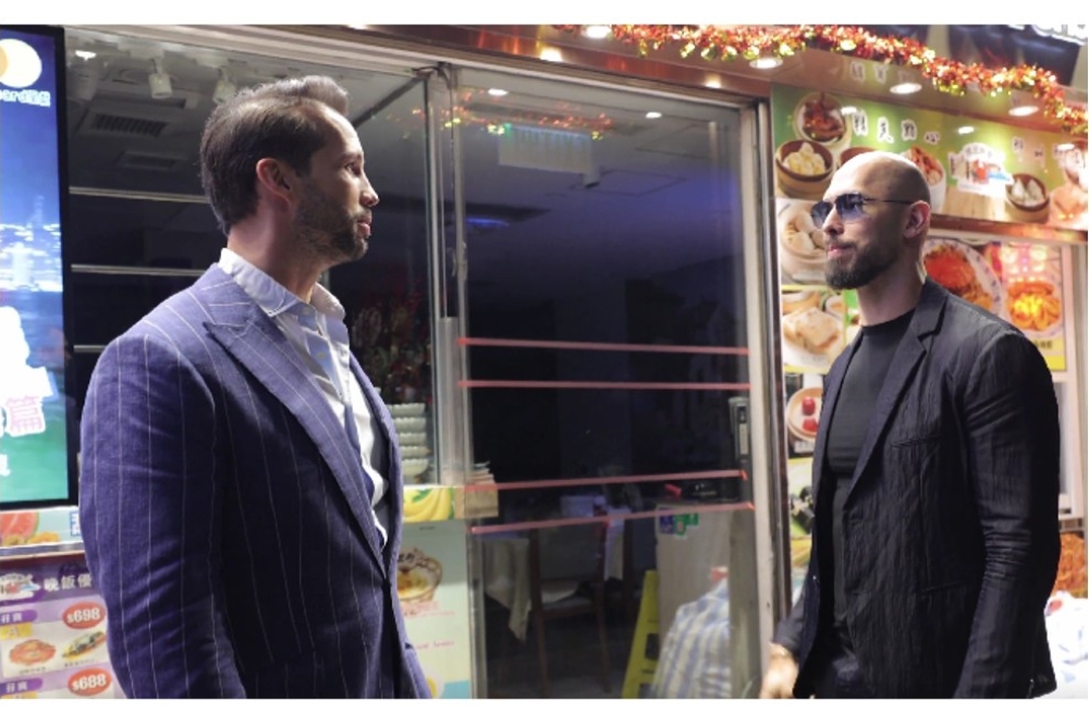 Online personalities Andrew (right) and Tristan Tate stand outside a restaurant in Hong Kong in a video shared on X. — Screengrab via X/@Cobratate