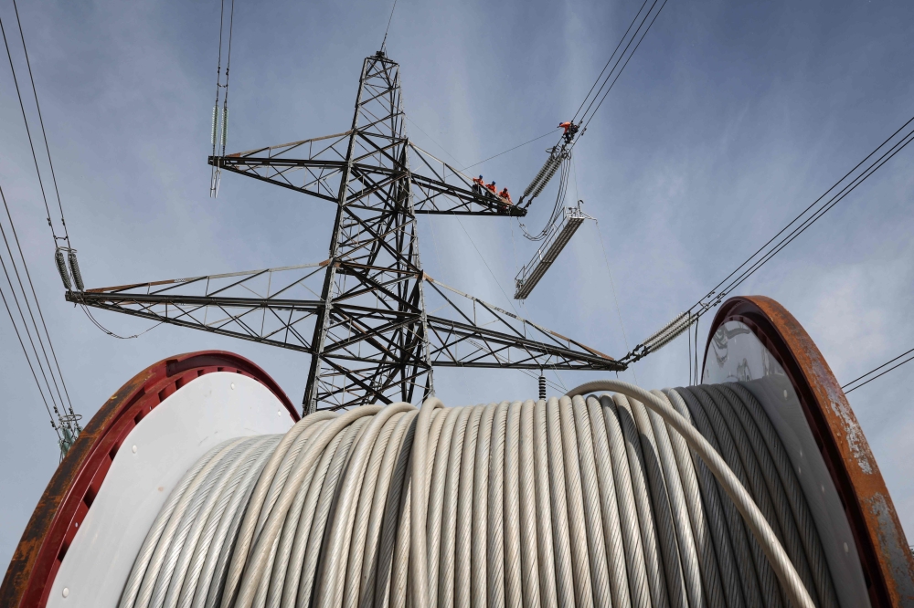 Three men were found dead, believed to have been electrocuted while attempting to steal cables in an open field at Taman Rapat Perdana here this morning. — AFP pic