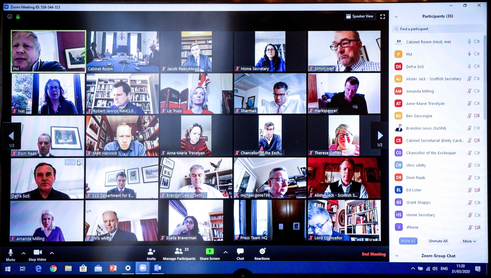 A still shows a video conference with Britain's Prime Minister Boris Johnson (top row, left) chairing a remote session with his Cabinet on March 31, 2020 in London. — AFP pic