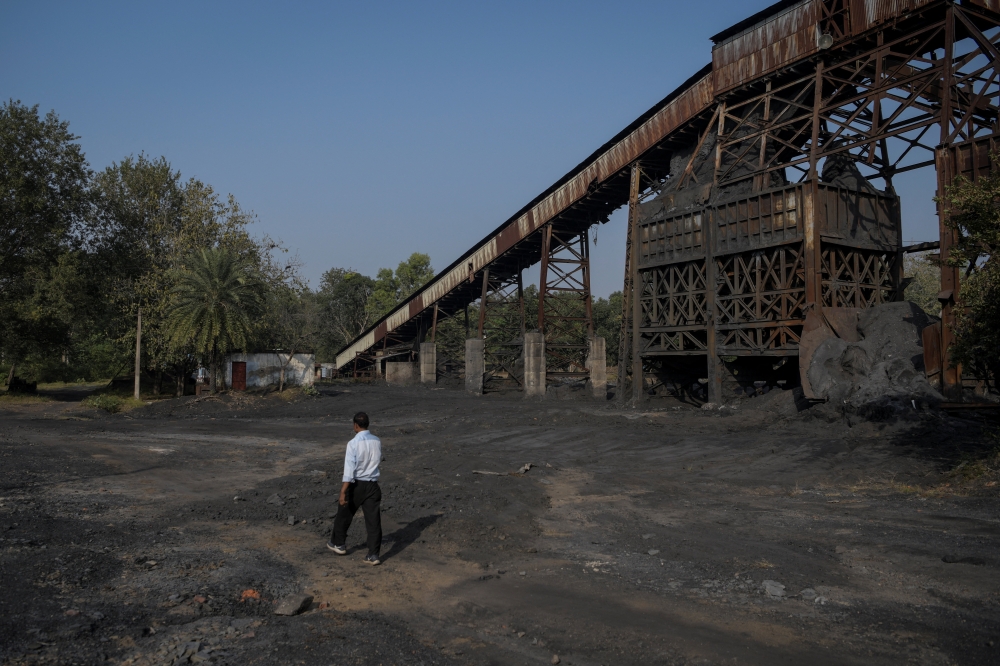 A South Eastern Coalfields Ltd (SECL) employee walks past a non‑operational underground coal‑mine entrance at the Bishrampur open‑cast mining area in Surajpur, India, November 15, 2025. — Reuters pic