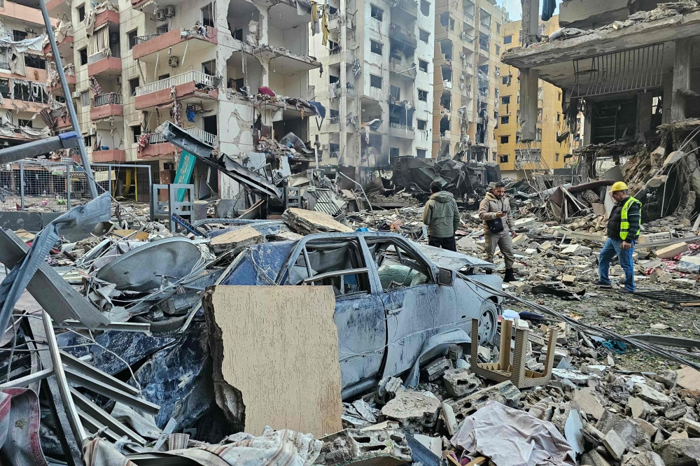 Men inspect the aftermath of Israeli airstrikes in Beirut’s southern suburbs on March 16, 2026. — AFP pic