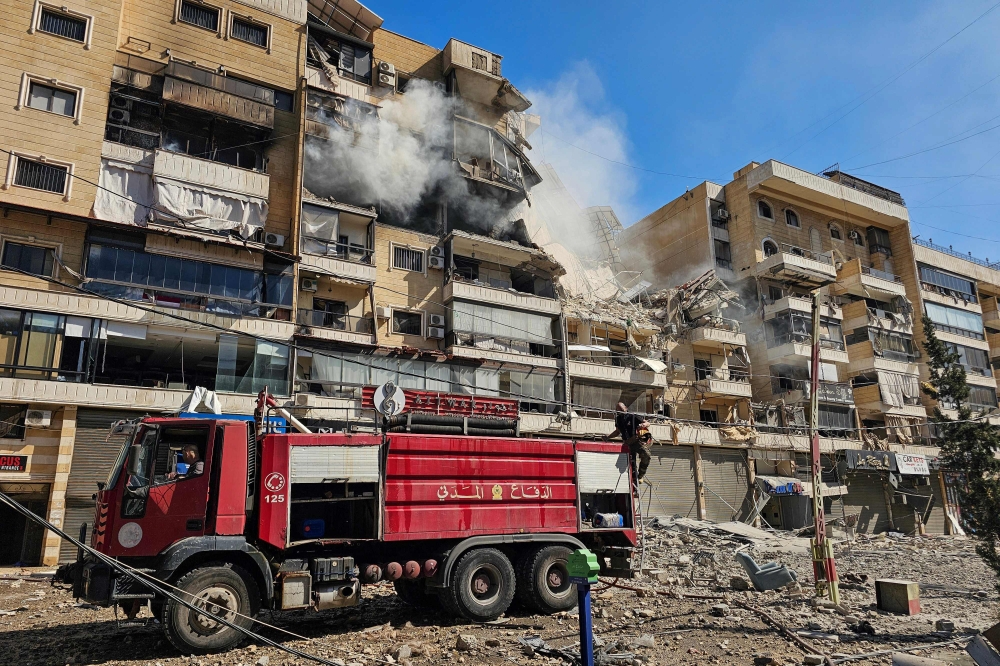 Firefighters at the site of an Israeli airstrike in the southern suburbs of Beirut on March 17, 2026. — AFP pic