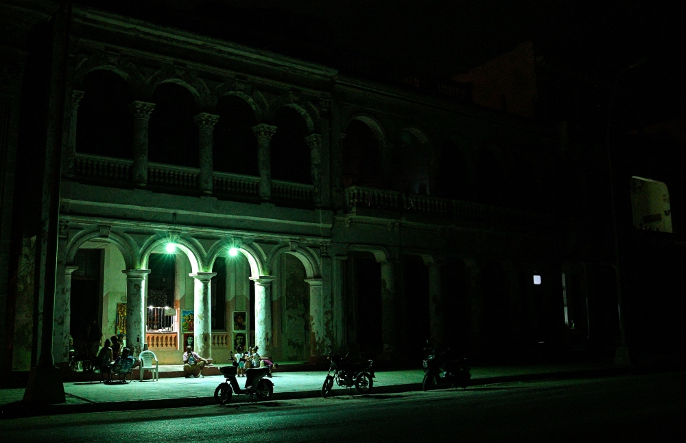Cubans gather in front of their houses during a blackout in Havana on March 16, 2026. — AFP pic