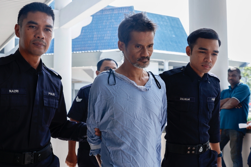 Saiful Hadi Othman, 44, (centre) was charged on March 18, 2026 with the March 11 murder of Muhamad Hanafi Yusof, 25, in a Sungai Udang, Melaka house but has not recorded a plea. His case is set for the High Court on April 29, 2026. — Bernama pic