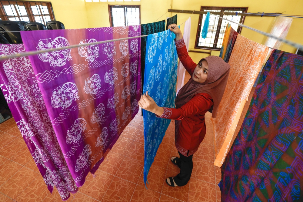 Sapinah said the community group is now struggling to keep up with demand for batik-based products, including clothing and accessories. — Bernama pic