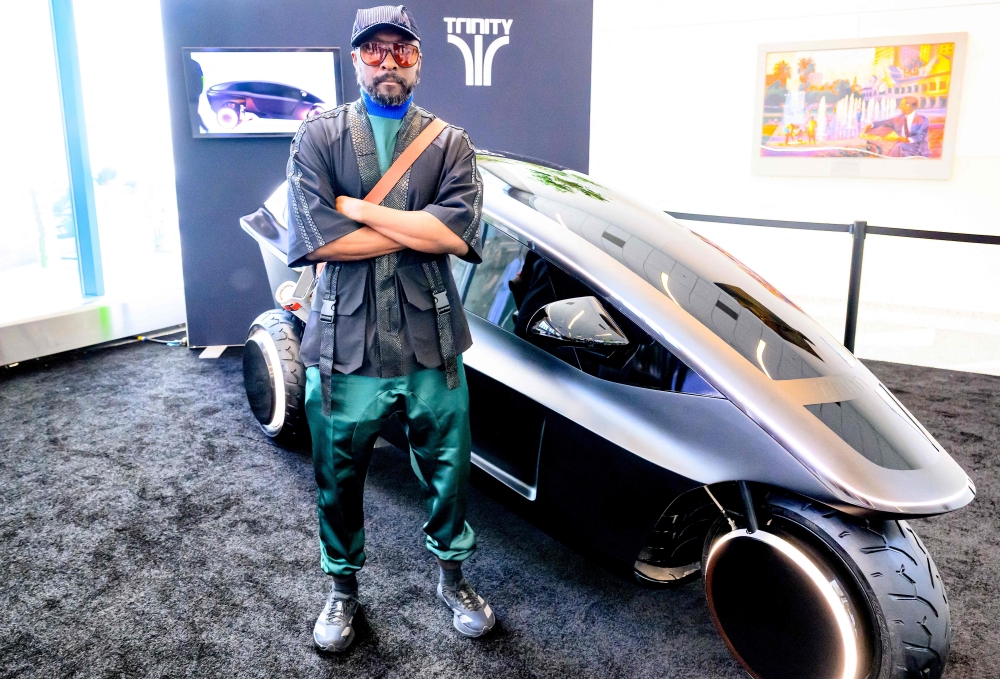 US musician and tech entrepreneur will.i.am poses for a photo in front of Trinity, an electric, AI-powered three-wheeled vehicle during NVidia’s annual GTC developers conference in San Jose March 17, 2026. — AFP pic