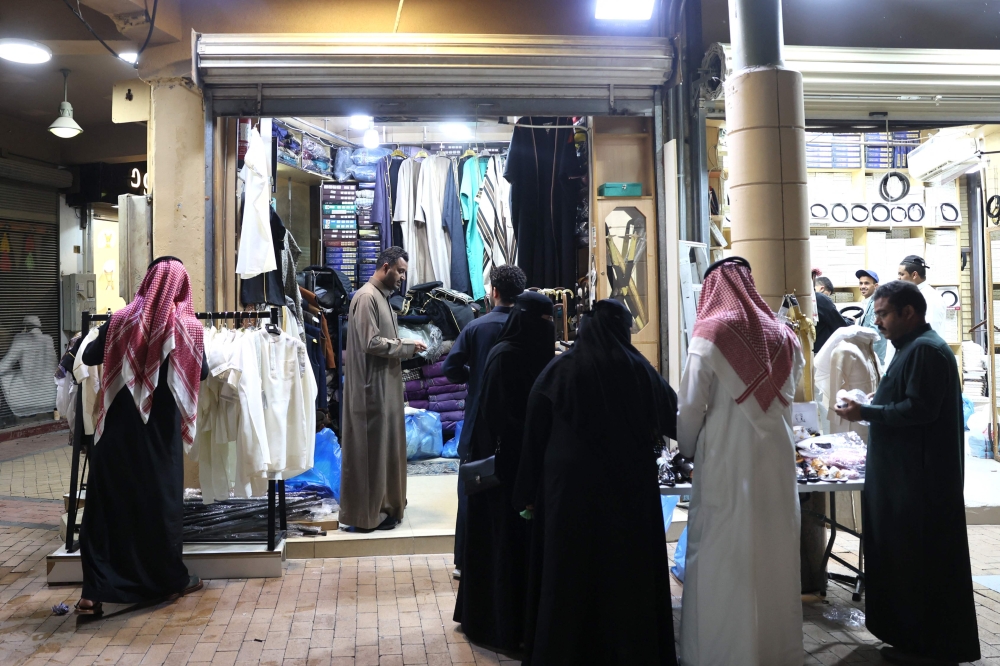 Saudis shop for clothes in the oldest popular Al- Zel market, in downtown Riyadh, on March 12. — AFP pic