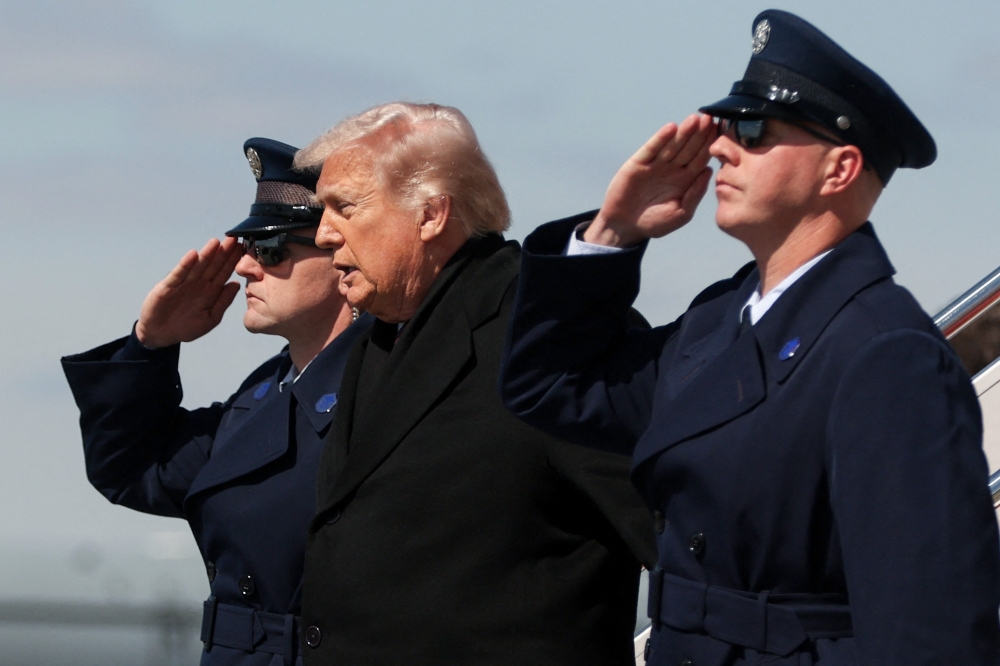President Donald Trump traveled to Dover to attend a dignified transfer ceremony honoring six US service members killed in a KC-135 refueling aircraft crash in Iraq. — AFP pic