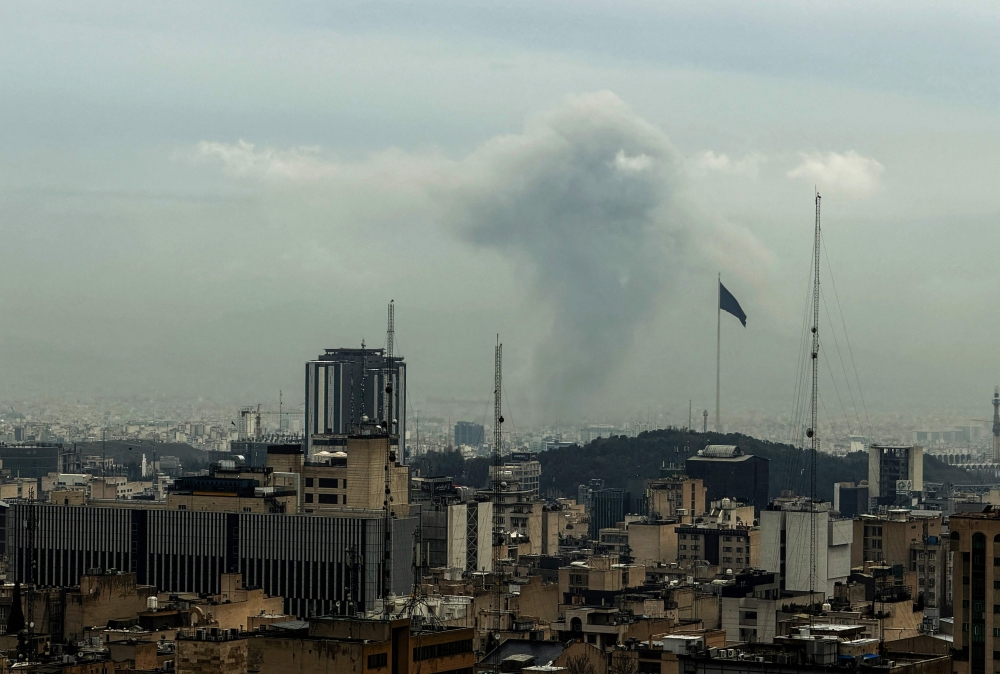A plume of smoke rises from the site of a strike in Tehran on March 16, 2026. — AFP pic