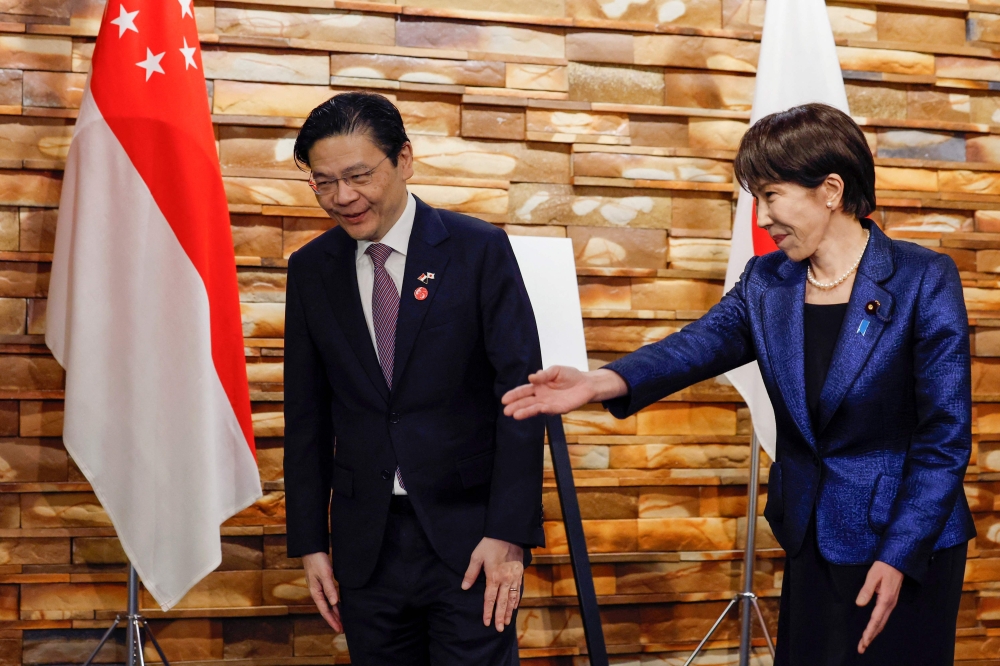 Singapore's Prime Minister Lawrence Wong (L) and Japan's Prime Minister Sanae Takaichi attend a bilateral meeting in Tokyo on March 18. — AFP pic