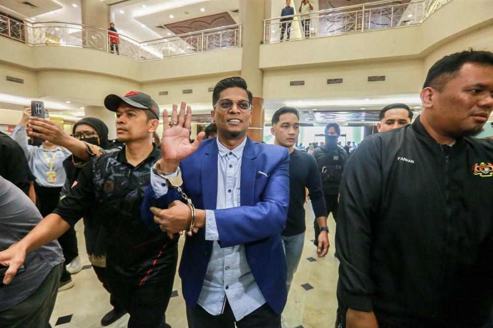 Preacher Zamri Vinoth is escorted by police to the Kuala Lumpur Court Complex on March 17, 2026. — Picture by Sayuti Zainudin
