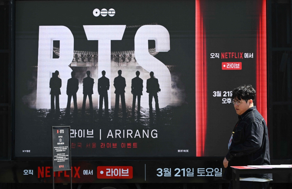 A man walks past a truck promoting the comeback concert of K-pop boy group BTS in Seoul on March 19, 2026. — AFP pic