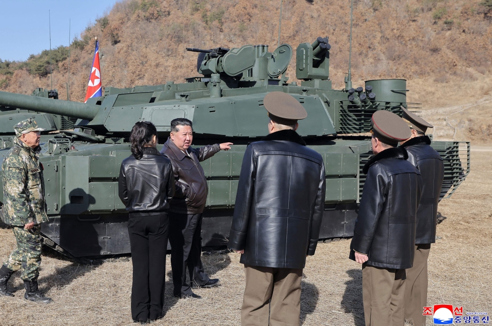 This picture taken on March 19, 2026 and released by North Korea's official Korean Central News Agency (KCNA) via KNS on March 20, 2026 shows North Korean leader Kim Jong Un and his daughter Kim Ju Ae visiting the Pyongyang Training Base No. 60 under the Capital City Defence Corps of the North Korean's Army.  — AFP pic
