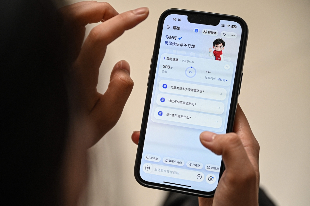 A patient uses the healthcare app AQ at her home in Shanghai on February 9, 2026. — AFP pic