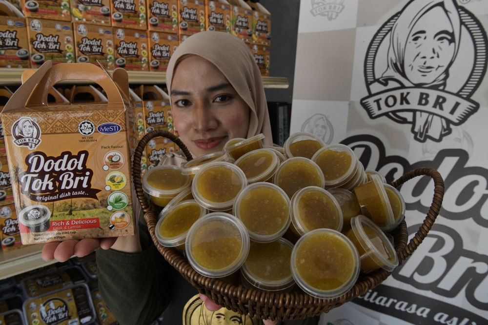 Dodol Tok Bri founder Nur Aimi Razak, 34, shows packs of pineapple dodol produced for sale in Kuala Sungai Pinang, Balik Pulau March 20, 2026. — Bernama pic.