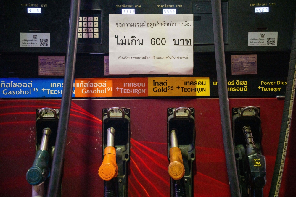 A notice imposing a 600-baht maximum purchase is displayed at a petrol station in Bangkok on March 17, 2026. Thailand is considering cuts to its oil tax, its finance minister said. — AFP pic 