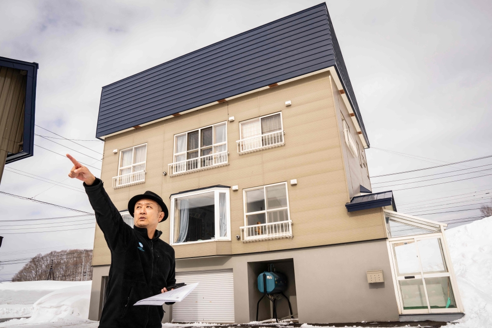 This picture taken on February 20, 2026 shows real estate agent Hiroshi Hasegawa presenting the view from a property in Niseko, Hokkaido prefecture. — AFP pic 