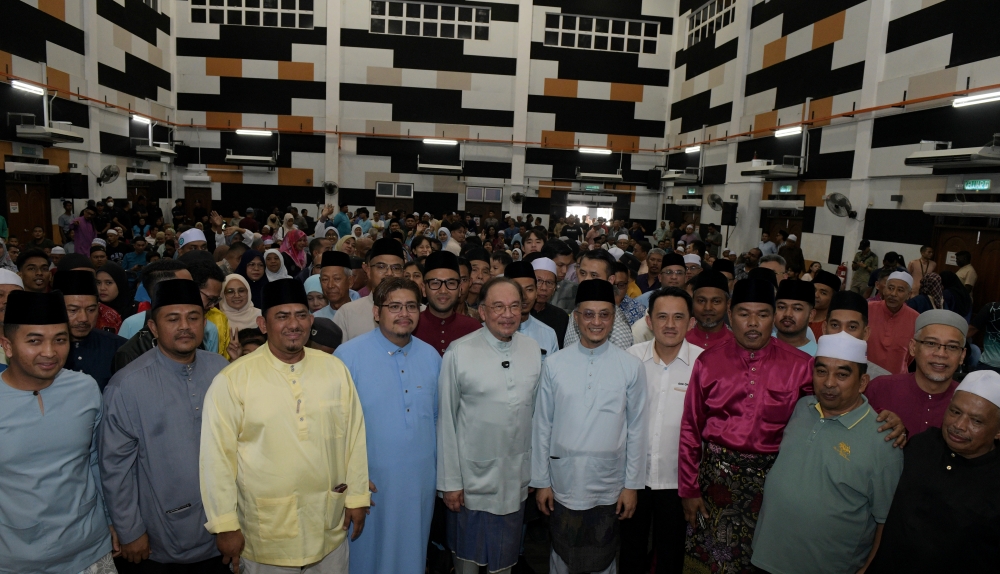 Prime Minister Datuk Seri Anwar Ibrahim poses for a photo with the public at an end-of-Ramadan relaxation programme with Permatang Pauh community leaders March 20, 2026. — Bernama pic