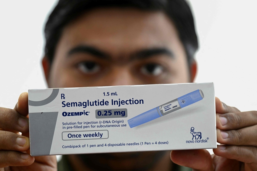 A medicine distributor displays a pack of Ozempic (semaglutide) self-injecting GLP-1 prefilled pens at his office in Thane on March 20, 2026. — AFP pic
