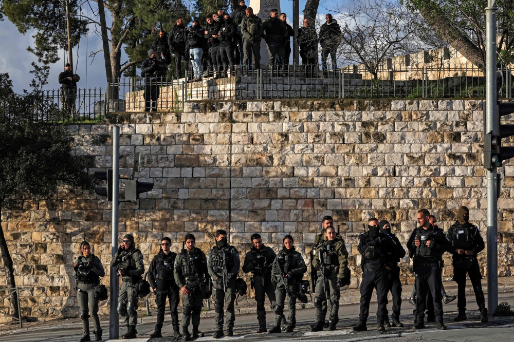 Israeli security forces stand guard as Muslim worshippers gather outside the Jerusalem old city walls on March 20, 2026 to attend attend the early morning prayers for Eid al-Fitr, marking the end of the holy month of Ramadan. — AFP pic