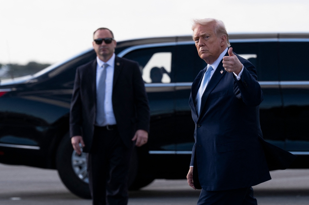 President Donald Trump gives a thumbs up after landing at Palm Beach International Airport on March 20, 2026, in Florida. — AFP pic