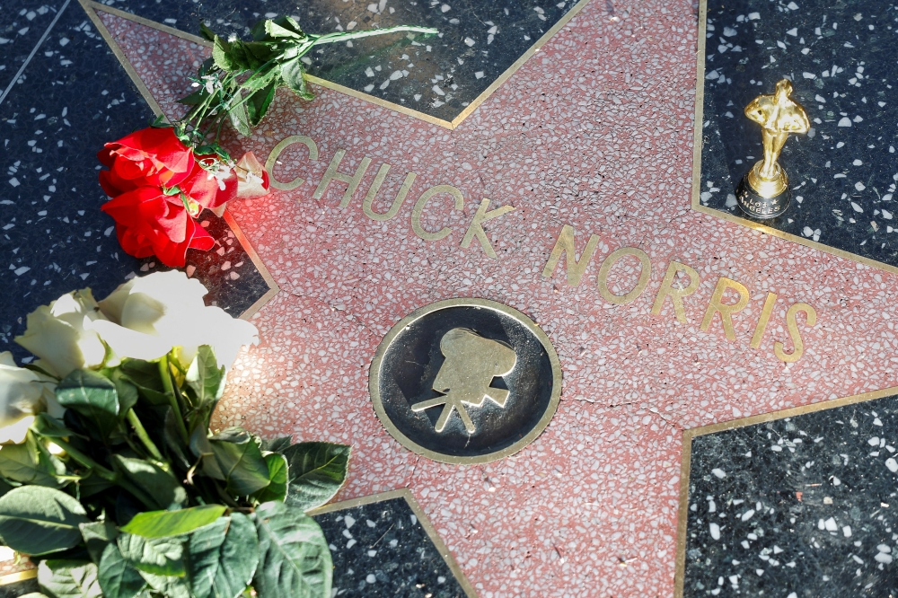 Flowers and a mock Oscar statuette sit over the star of actor Chuck Norris following his death, on the Hollywood Walk of Fame in Los Angeles, California, US, March 20, 2026. — Reuters pic