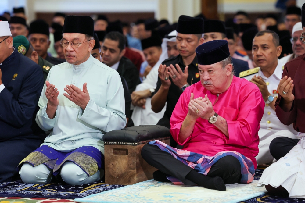 His Majesty Sultan Ibrahim, King of Malaysia, and Prime Minister Datuk Seri Anwar Ibrahim pray while listening to the sermon after performing the Aidilfitri Sunat Prayer at the Main Surau of Istana Negara March 21, 2026. — Bernama pic