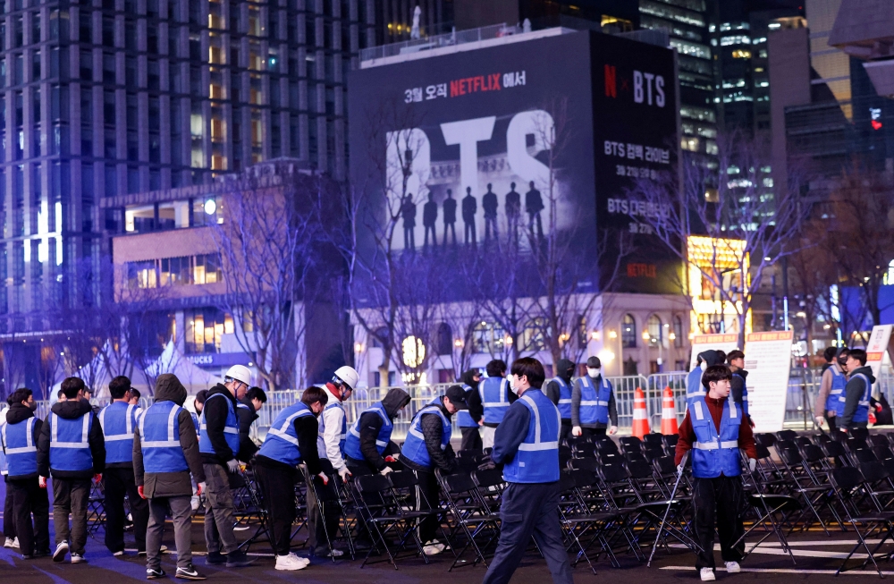 Workers organize chairs at the temporarily restricted Gwanghwamun square that will be used for ‘BTS The Comeback Live Arirang’ concert, Kpop boy band BTS’ first performance in more than three years since completing mandatory military service, the night before the concert in Seoul, South Korea, March 20, 2026.  — Reuters pic