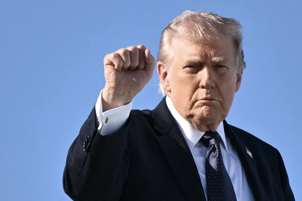 US President Donald Trump gestures as he boards Air Force One before departing Palm Beach International Airport in West Palm Beach, Florida, on March 1, 2026, on his way back to Washington, DC. — AFP pic 