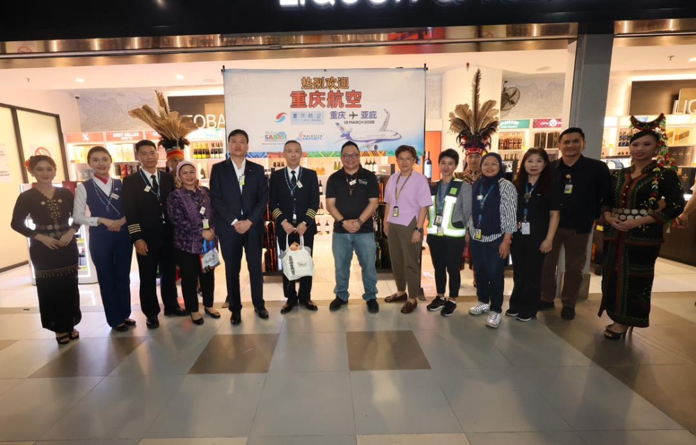 STB chief executive officer Julinus Jeffery Jimit and other officials in a group photo at KKIA arrival hall. — The Borneo Post pic 