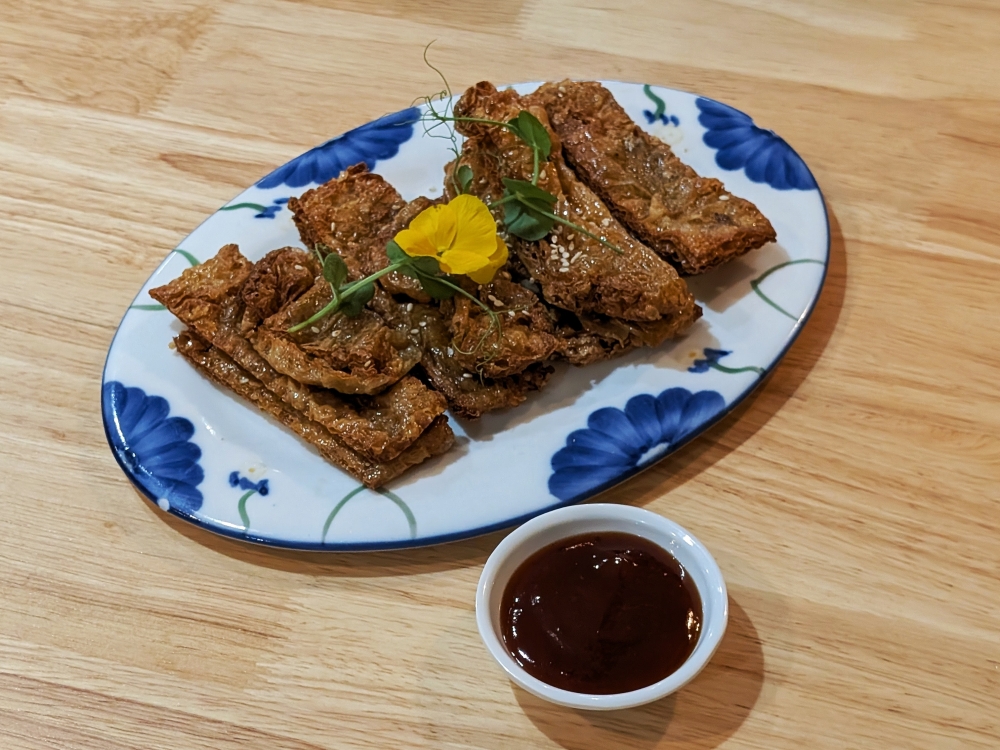 Dipping these traditional goose sheets in the curry proves to be one of the most satisfying vegetarian experiences one can enjoy. — Ethan Lau