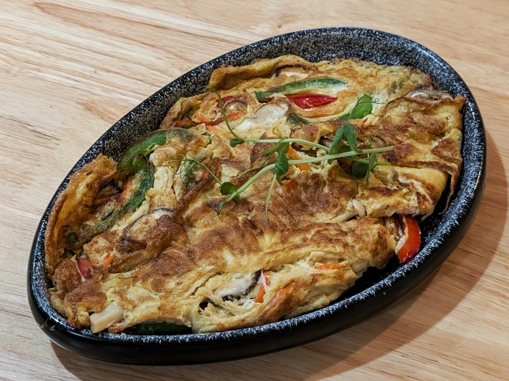 The Fu Yong Omelette at Botanique is made with ‘macao’ eggs, a variety with nutrient-dense yolks laid by hens fed with Napier grass. — Ethan Lau