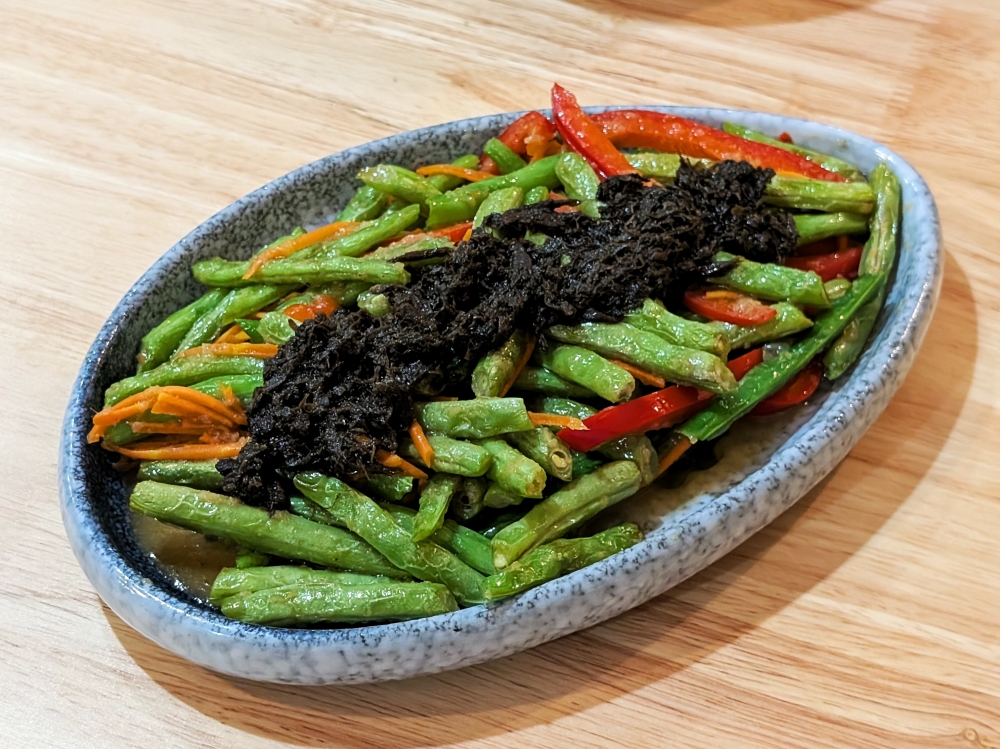 Even a simple plate of French beans with preserved olives and mustard greens stands out here. — Ethan Lau